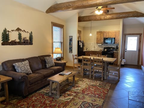 Living room with vaulted ceilings and log accents.