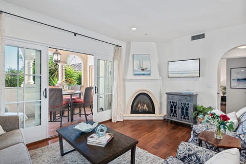 Living room opens out to covered balcony and features fireplace