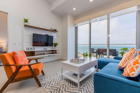 Sink into plush seating in your bright living room, where ocean views greet you through floor-to-ceiling windows and the balcony beckons.