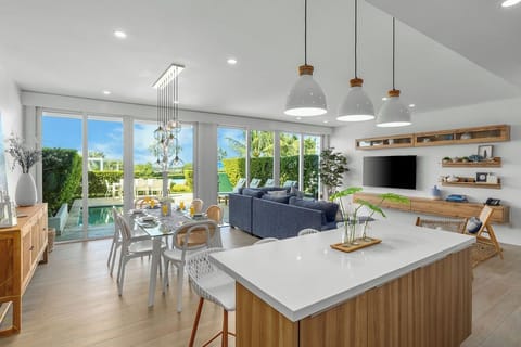 Relax in this bright open-plan space where modern kitchen flows into dining and living areas, overlooking tropical gardens and pool.