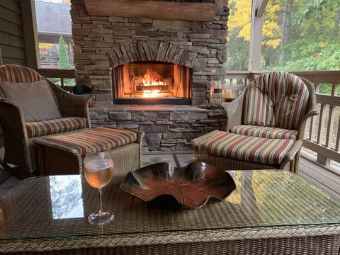 Screened in porch with fireplace for relaxing with friends and family.