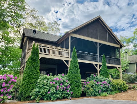 Large screened porch overlooks beautiful landscape on 14 Trillium Links Cashiers