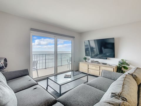 Coastal living room with access to the oceanfront balcony.