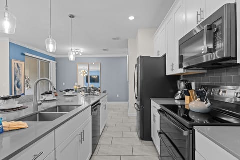 Your modern kitchen awaits with sleek stainless steel appliances, spacious granite counters, and stylish pendant lighting for memorable meal prep.