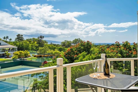 View of the tennis courts, lush landscape and the ocean from the lanai.