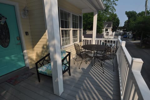 Partially covered porch withing table for dining, playing games, etc.