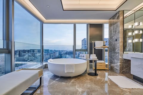 Deluxe Suite, 1 King Bed | Bathroom | Separate tub and shower, bathrobes, slippers, towels