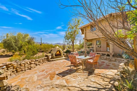 Chiminea outdoor fireplace on a flagstone patio & a grey water sink