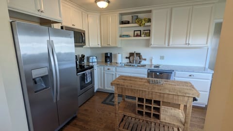 Remodeled kitchen with newer cabinets and stainless steel appliances.