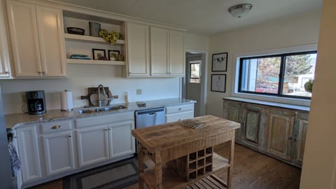 Remodeled kitchen with newer cabinets and stainless steel appliances.