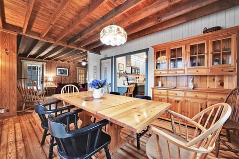 dining room with seating for everyone around huge table overlooking the lake