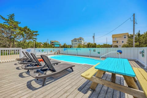 Lounge poolside under clear blue skies, soak up the sun on comfortable chaise lounges, or gather at the colorful picnic table for refreshments and conversation.