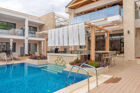 Seasonal outdoor pool, open 10:00 AM to 8:00 PM, pool umbrellas