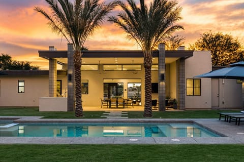 Relax in this modern Scottsdale home with a private pool, palm-lined patio, and plenty of sunshine.