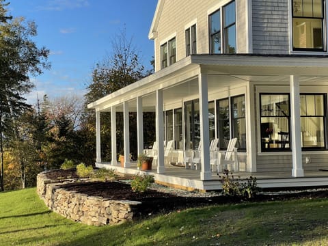 Front porch faces the ocean, islands and mountains of Frenchman's bay.