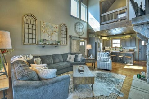 Luxurious living room with stone gas fireplace, smart/satellite TV, and cozy furniture