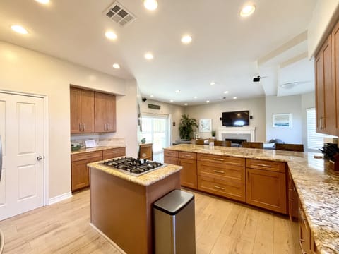 Open floor plan with kitchen and family/TV room together