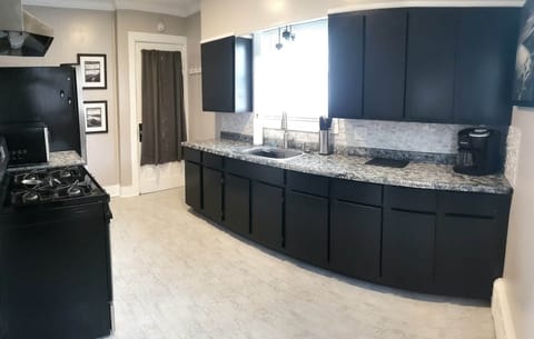 Kitchen, with back door to enter into back mudroom also access back patio