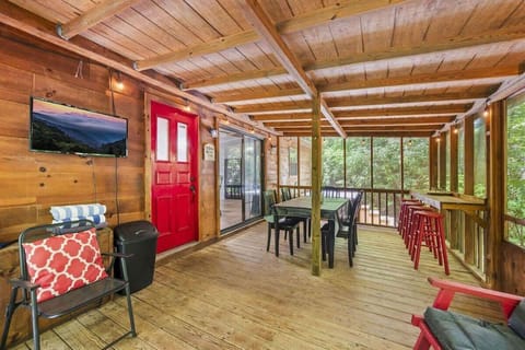 Covered and screened-in porch by the creek, perfect for relaxing outdoors and enjoying the peaceful sounds of nature.