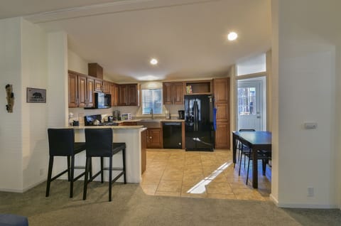 View of kitchen with bar stools