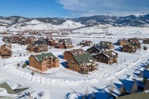 Mountain resort community nestled in pristine snow-covered valley with spectacular alpine scenery and winter recreation nearby.