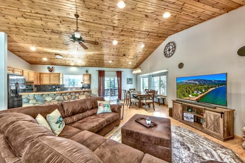 Relax in your cozy living space with rustic wood ceilings, leather seating, and mountain views on the big screen TV.