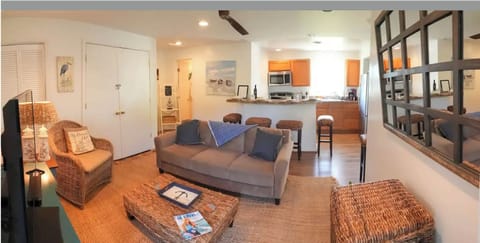 View from front door - cozy living room with open kitchen and bar seating