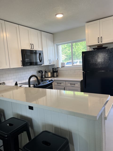 Kitchen with breakfast bar seating for four