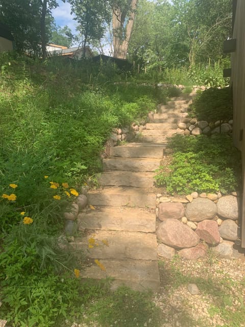 The stone staircase leads to the patio at the back of the house.