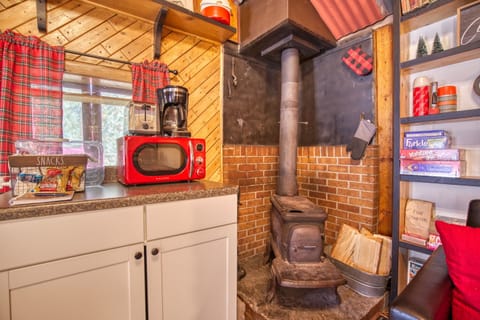 Antique wood burning stove with complimentary firewood during your stay.