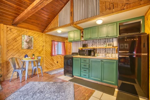Inviting great room with vaulted ceiling and SmartTV. Enjoy the antique wood burning stove and complimentary firewood during your stay.