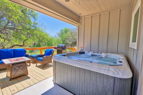 Covered hot tub next to the entertaining area
