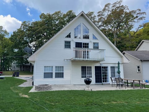 Canal-side view of back patio, firepit, lawn