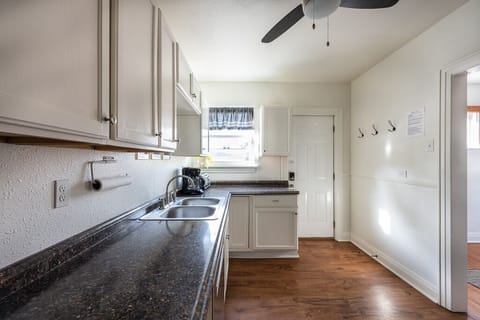 Essential kitchen utensils and cookware are available.