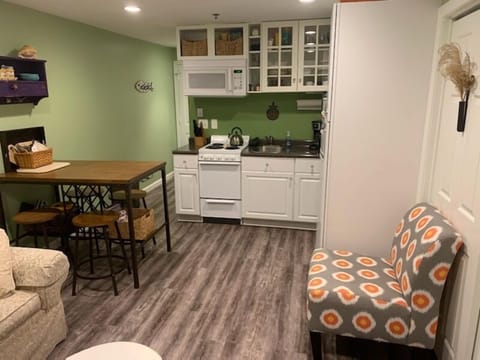 Kitchen area complete with apartment size stove/oven, full size fridge, microwave, and coffee maker.