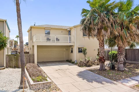 Front of the house. 2 stories with a garage, paved driveway, and balcony. 