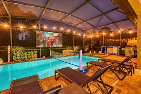 Enjoy an outdoor movie by the pool and spa!