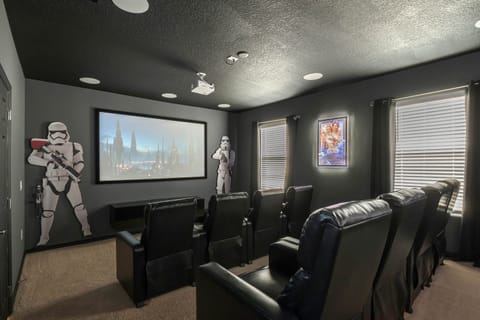 - Private home theater with plush recliner seating for guests  
- Movie nights with surround sound and cinematic screen  
- Orlando vacation rental featuring immersive cinema room
