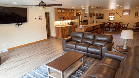 Living Room - Main Level. Cozy living room with chair, couch, ceiling fan and TV.