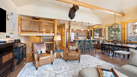 Open concept living room, dining area, kitchen, and outdoor dining space.