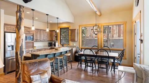 Open concept living room, dining area, fully stocked kitchen, and outdoor dining space.