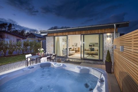 Hot tub in the patio area, sliding doors and table seating for 4 guests outside - Salt Life, Dunes at Upton Towans