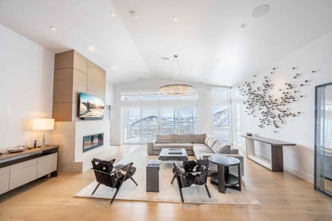Expansive living room with floor-to-ceiling windows and mountain views in this Park City ski-in/ski-out penthouse