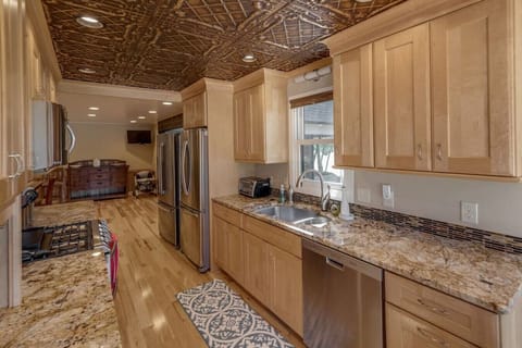 Kitchen area with wooden cabinets, sink and double door ref