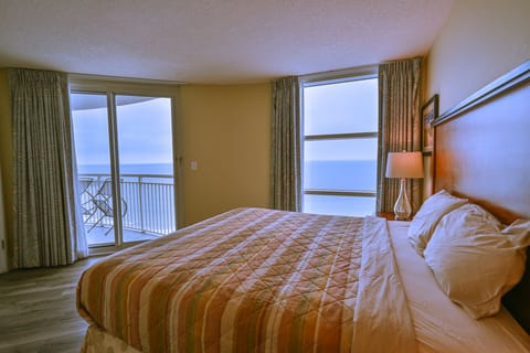 Master bedroom with cozy decor, serene vibe, and stunning oceanfront views.