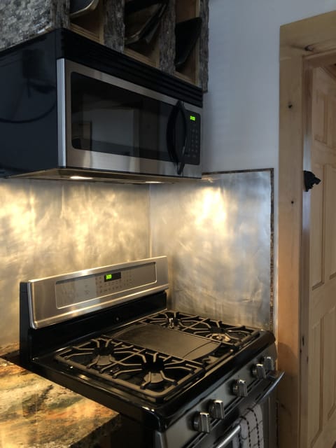 Gas stove top and oven with microwave.