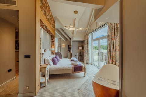 Junior Suite, Patio, Lake View | Iron/ironing board, WiFi (free), bed sheets