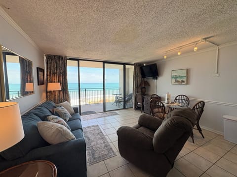 interior, indoor dining, couch, balcony, living area, TV , dining table,