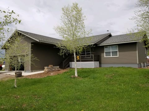 Front of house with porch and two-car garage.