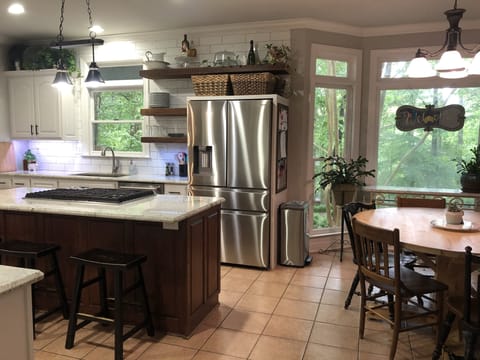 Kitchen has bay window  breakfast eating area open to den.